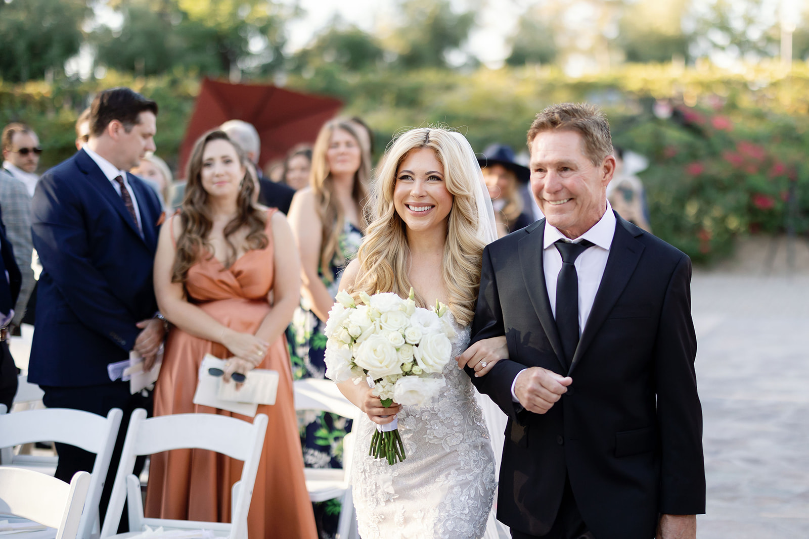 Bride walking down the aisle with her dad during a Lake Oak Meadows wedding in Temecula California.