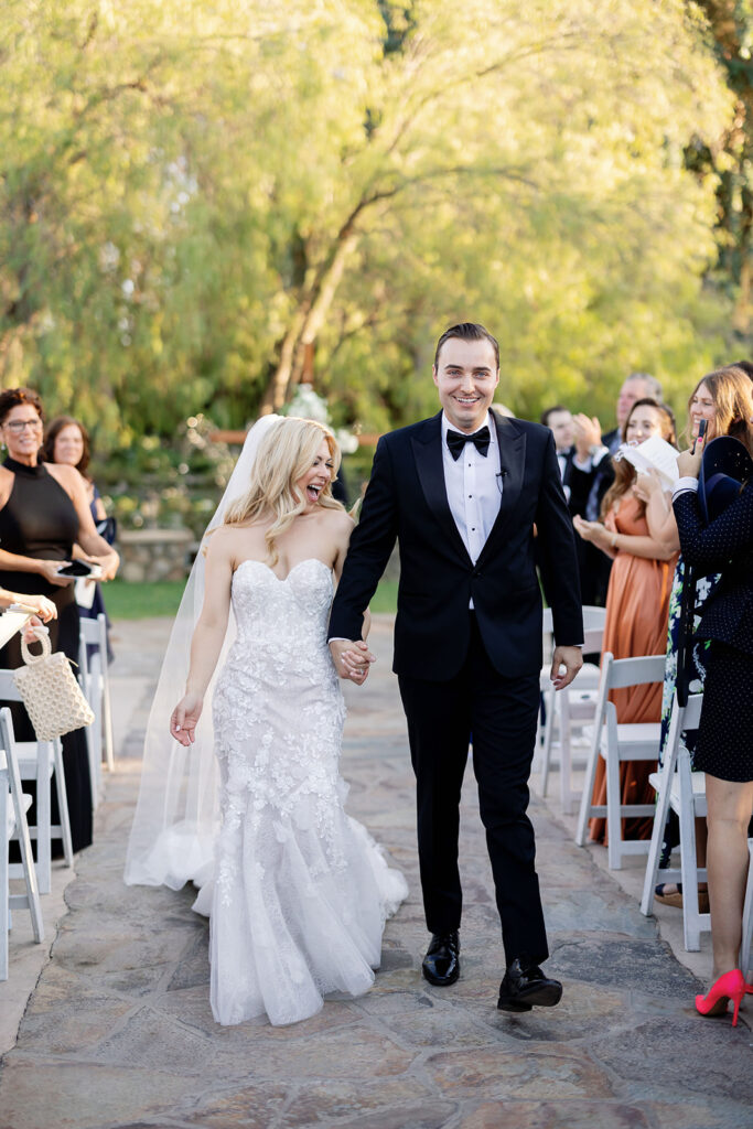 Bride and groom walking back down the aisle after their Lake Oak Meadows wedding ceremony.