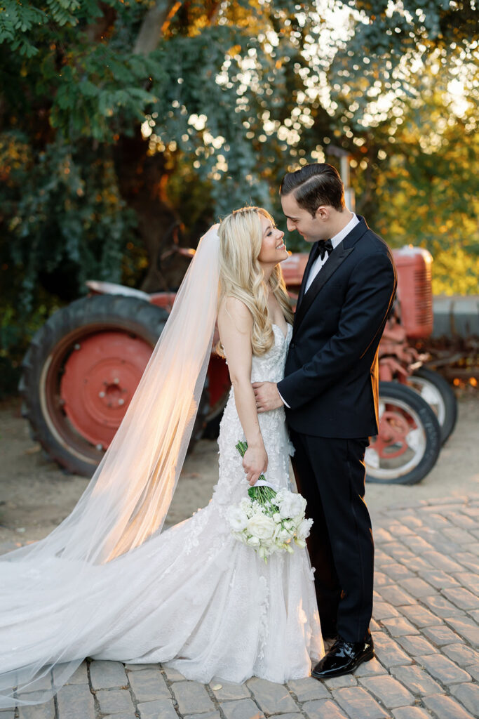 Bride and groom posing outside for their golden hour Lake Oak Meadows wedding in Temecula.