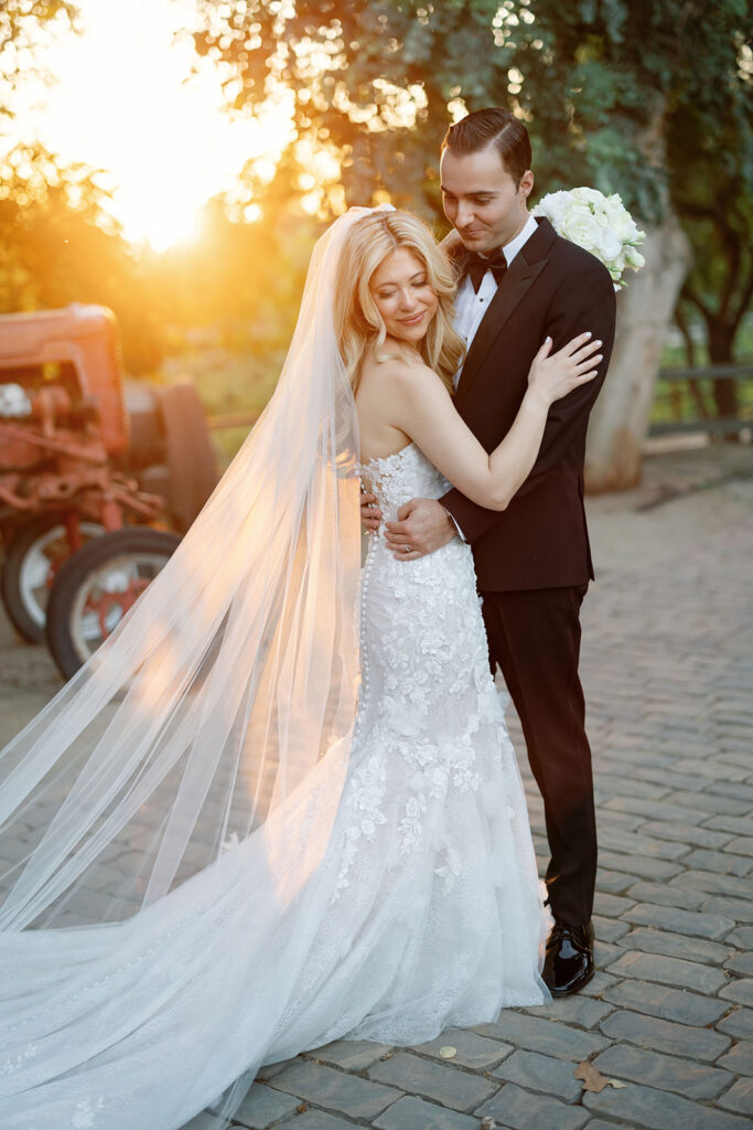 Bride and groom posing outside for their golden hour Lake Oak Meadows wedding in Temecula.