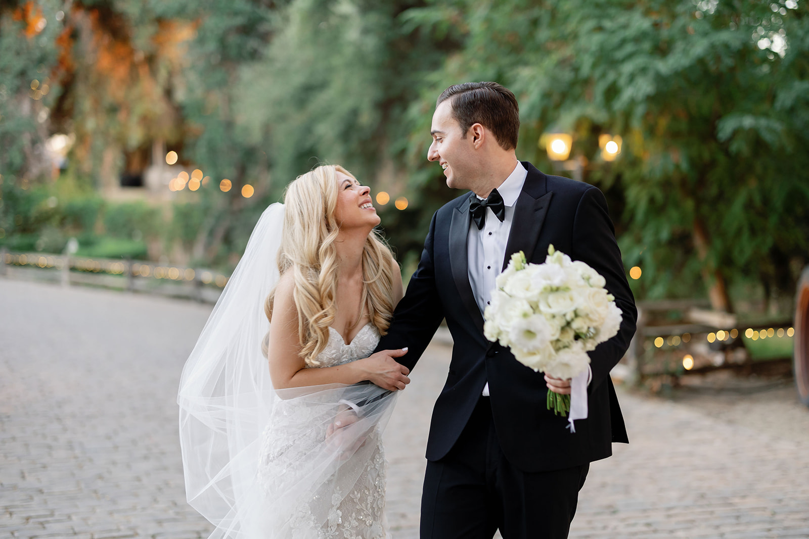Bride and groom smiling at each other during their Lake Oak Meadows wedding in Temecula, California.