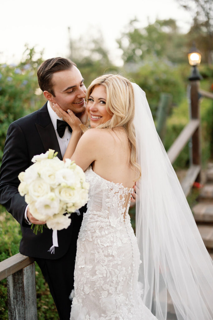 Close up photo of a bide and groom posing together and smiling.