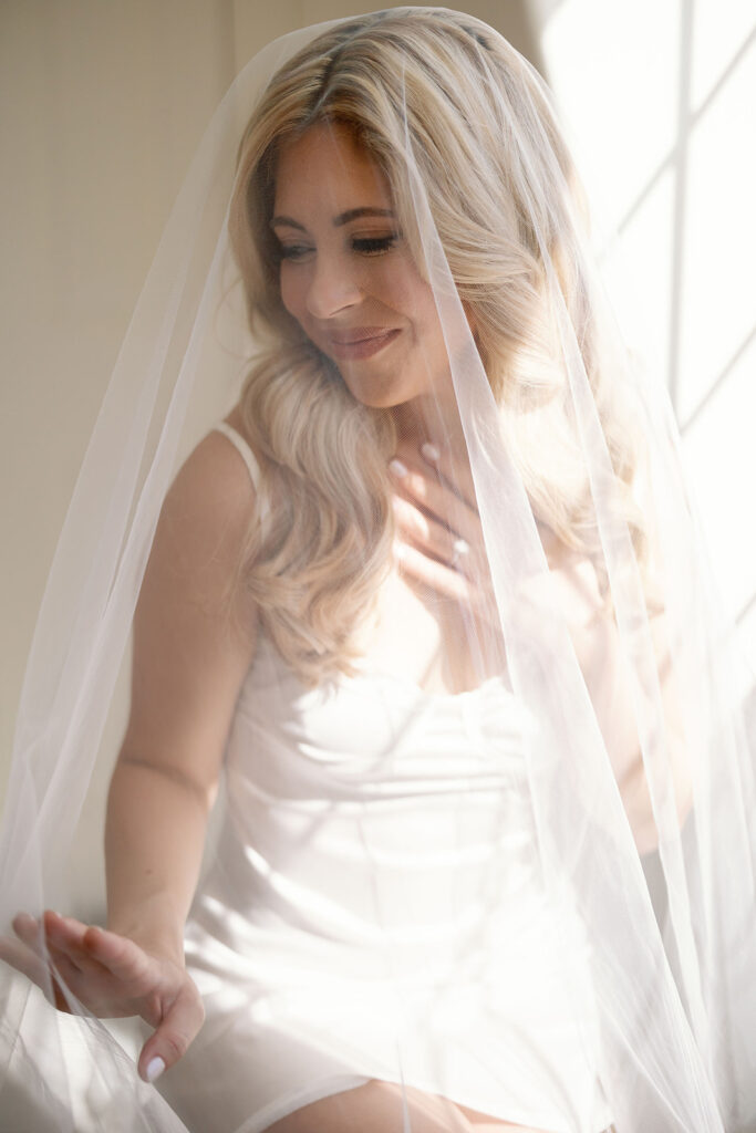 Bride wearing her veil during soft window light portraits at Lake Oak Meadows in Temecula California.