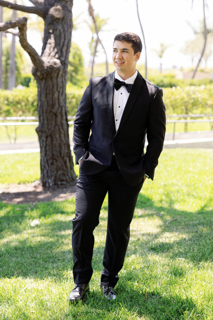 Groom wearing a classic black tuxedo for an outdoor Newport Beach hotel wedding.