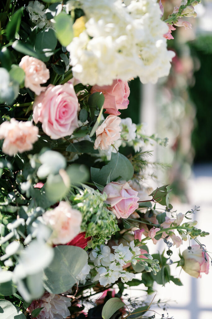 Pink roses, white hydrangeas, and greenery arranged for a Hyatt Regency Newport Beach wedding ceremony.