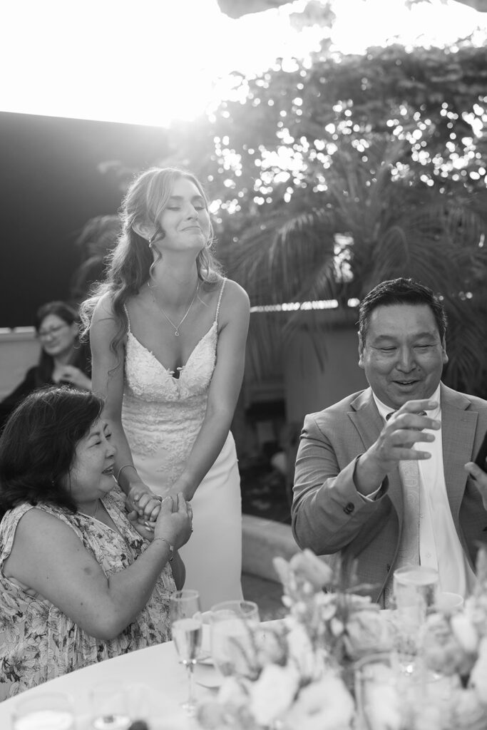 Bride smiling as she mingles with guests during her Hyatt Regency Newport Beach wedding reception in the garden.