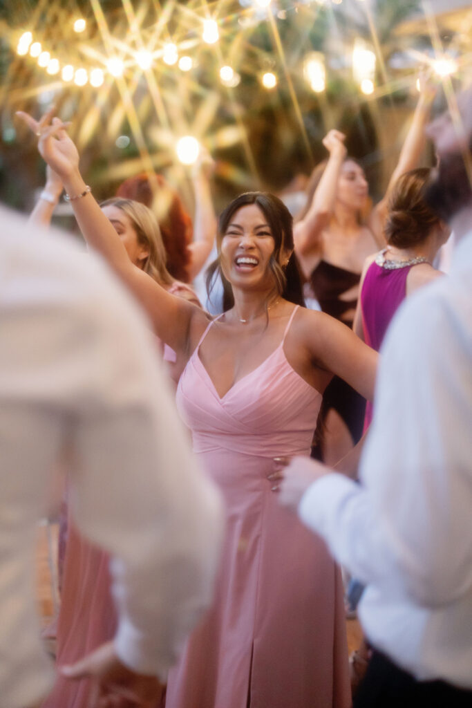 Guest dancing under twinkle lights during a Newport Beach wedding reception.