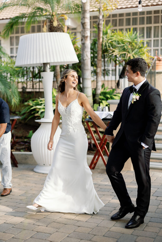 Bride and groom making their entrance into their Hyatt Regency Newport Beach wedding reception in the Garden.