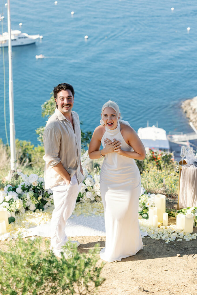 Woman shocked at the camera after her surprise proposal on Catalina Island at Buena Vista Point. 