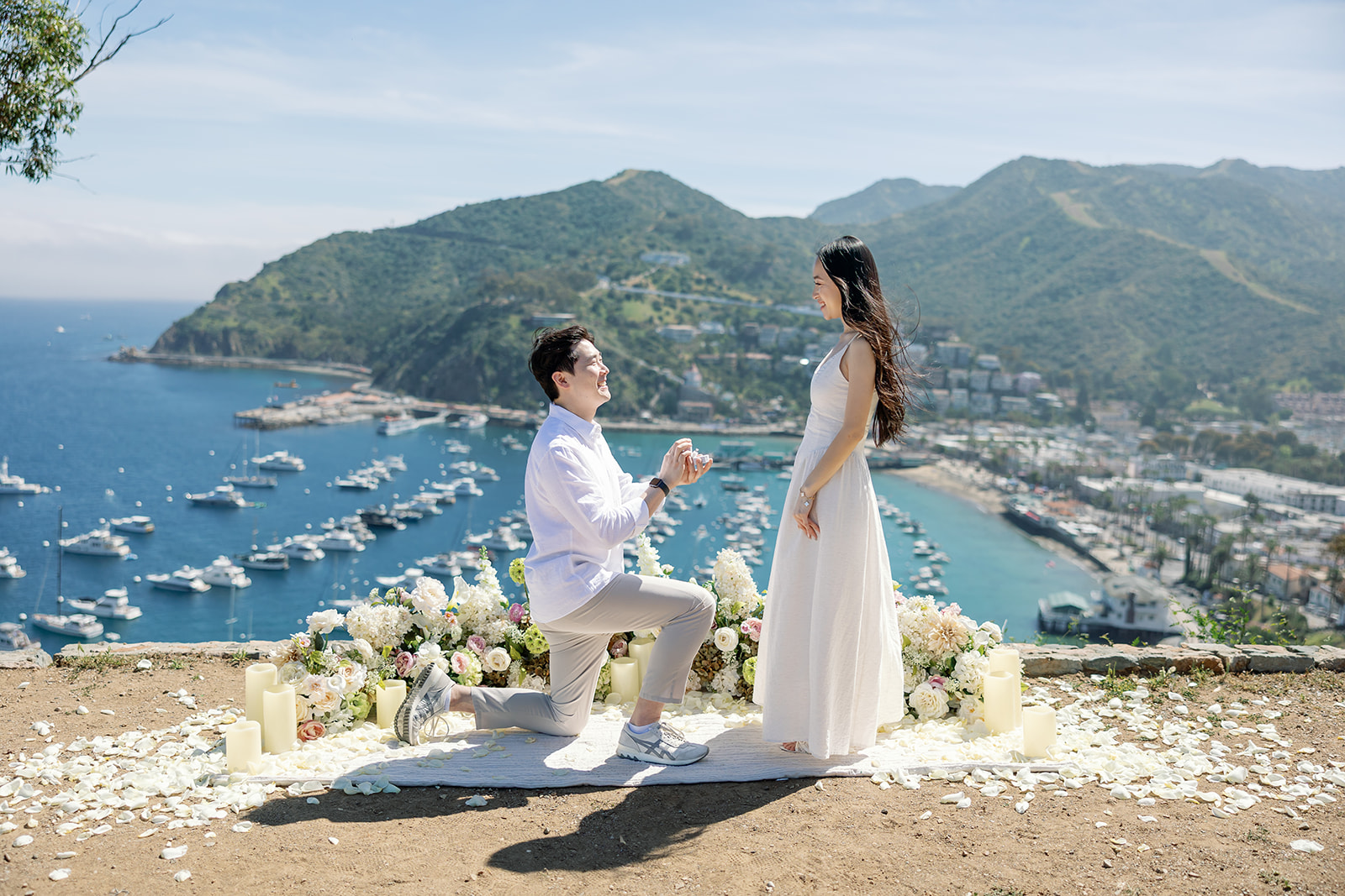 Man kneeling as he proposes to his fiancé during their Catalina Island proposal at Lee’s Scenic Overlook.