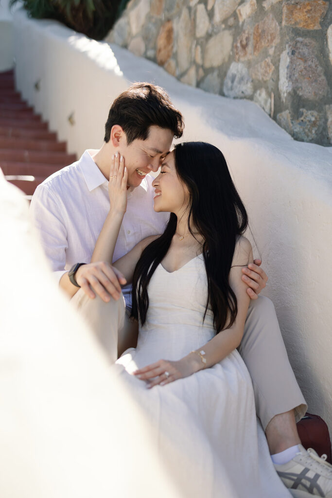 Couple posing on stairs for their Catalina Island engagement photos.