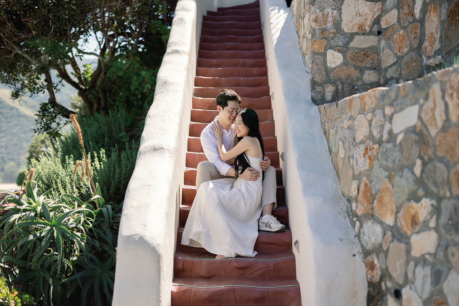 Couple posing on stairs during their Catalina Island engagement photos.