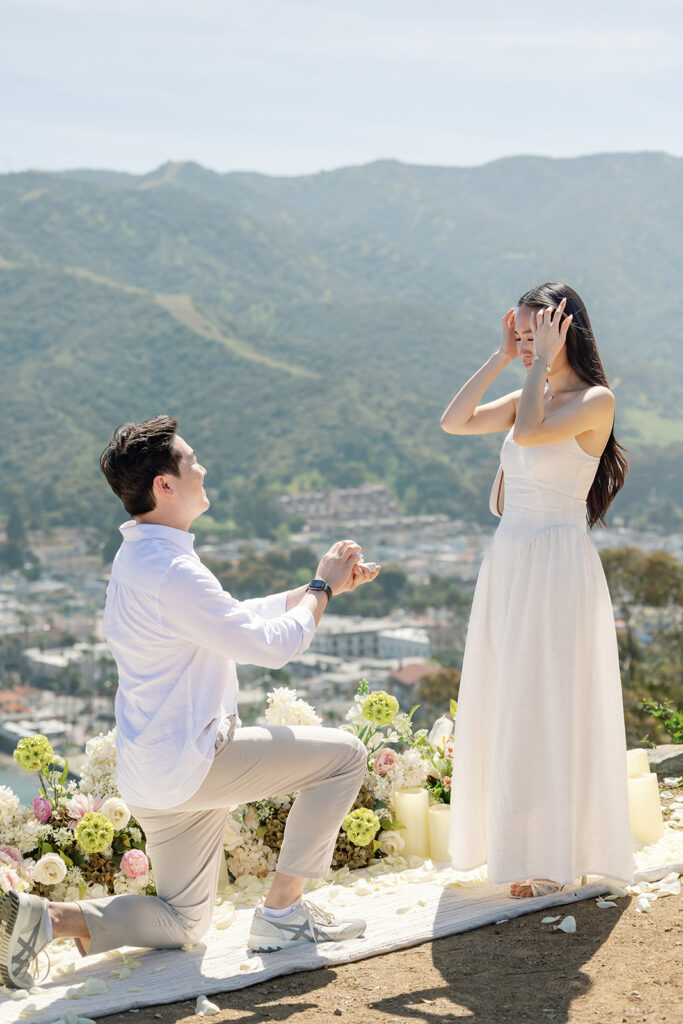 Man kneeling with a ring during his Catalina Island proposal at Lee’s Scenic Overlook.
