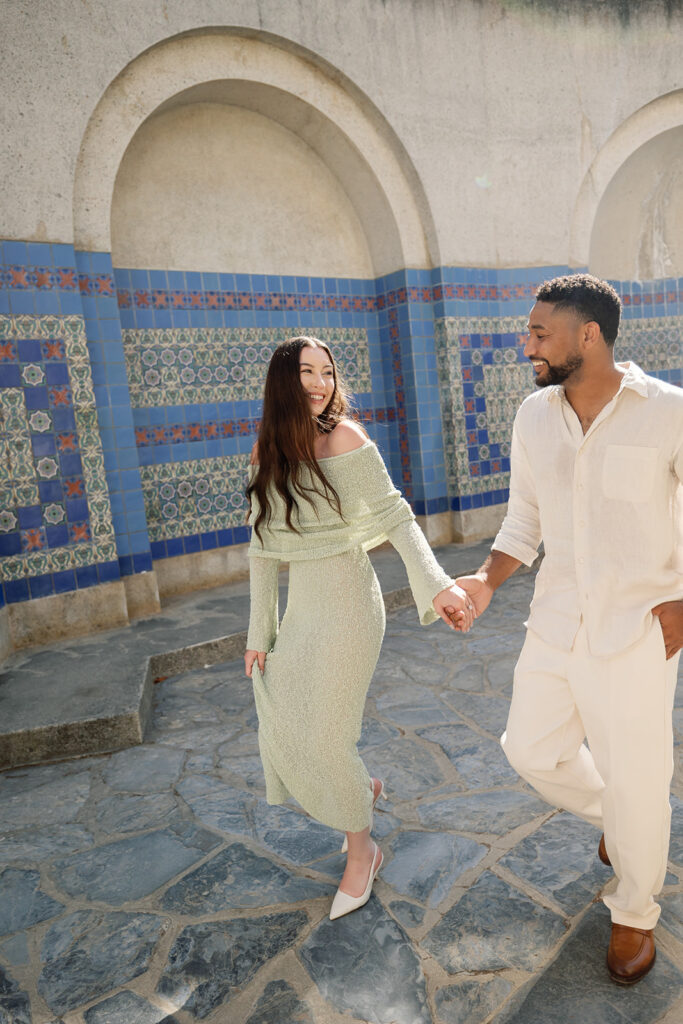 Couple walking hand in hand for their Catalina Island engagement photos at Wrigley Memorial & Botanic Garden.