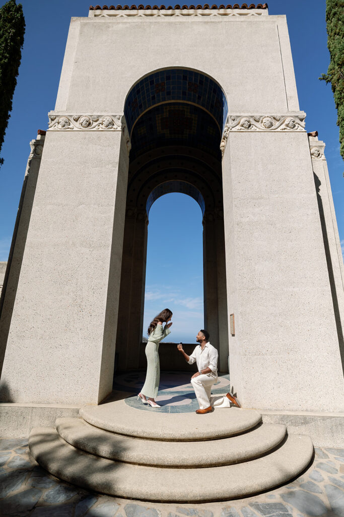 Man kneeling as he proposes to his fiancé during their Catalina Island proposal at Wrigley Memorial & Botanic Garden.