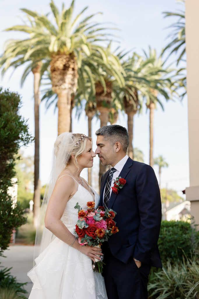 Bride and groom posing together for their Orange County wedding photos.
