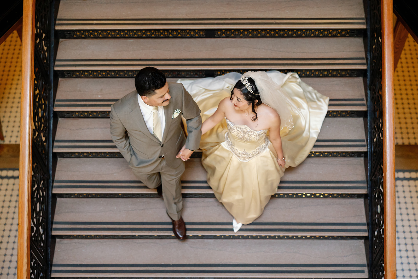 Bride and groom walking down the staircase for their Old Orange County Courthouse wedding photos in Santa Ana, California.