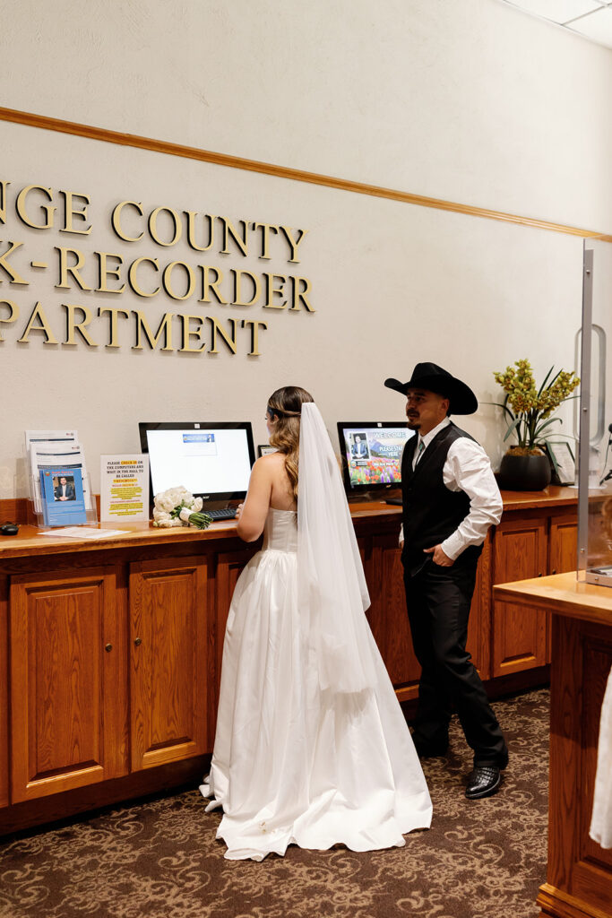 Bride and groom checking in for their Old Orange County Courthouse wedding in Santa Ana, California.