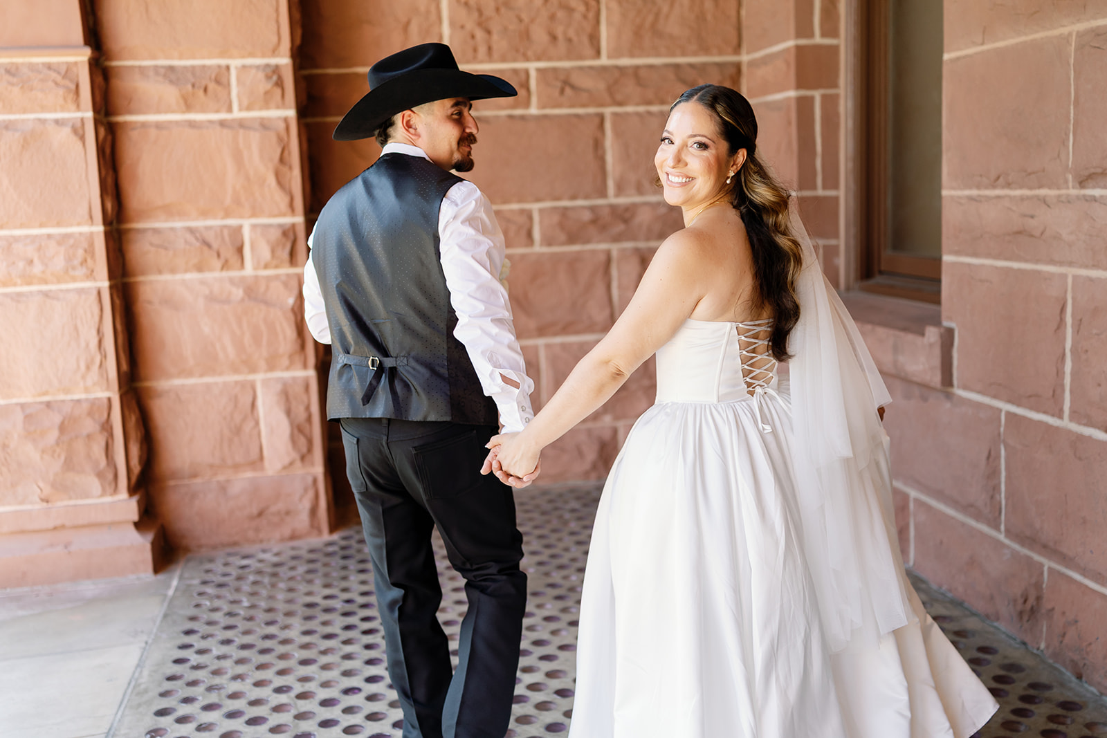 Bride and groom walking outside of the courthouse.