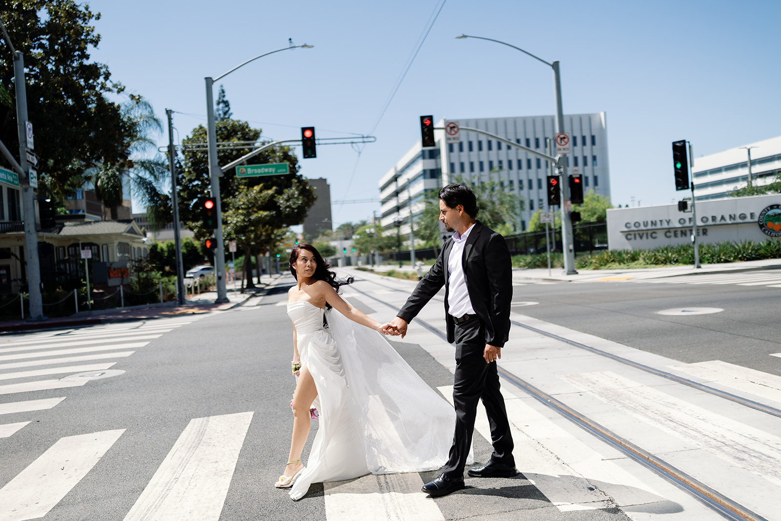 Bride and groom walking across the street for some Orange County wedding photos.