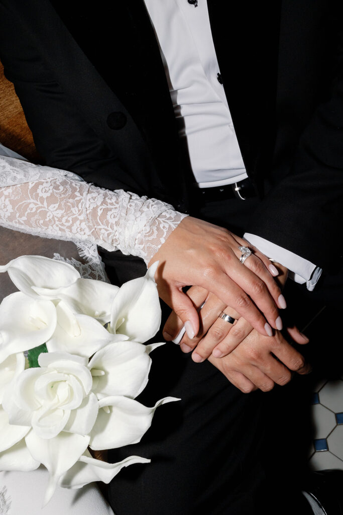 Bride and groom holding hands.