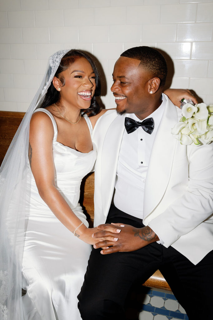 Flash candid photo of a bride and groom laughing.