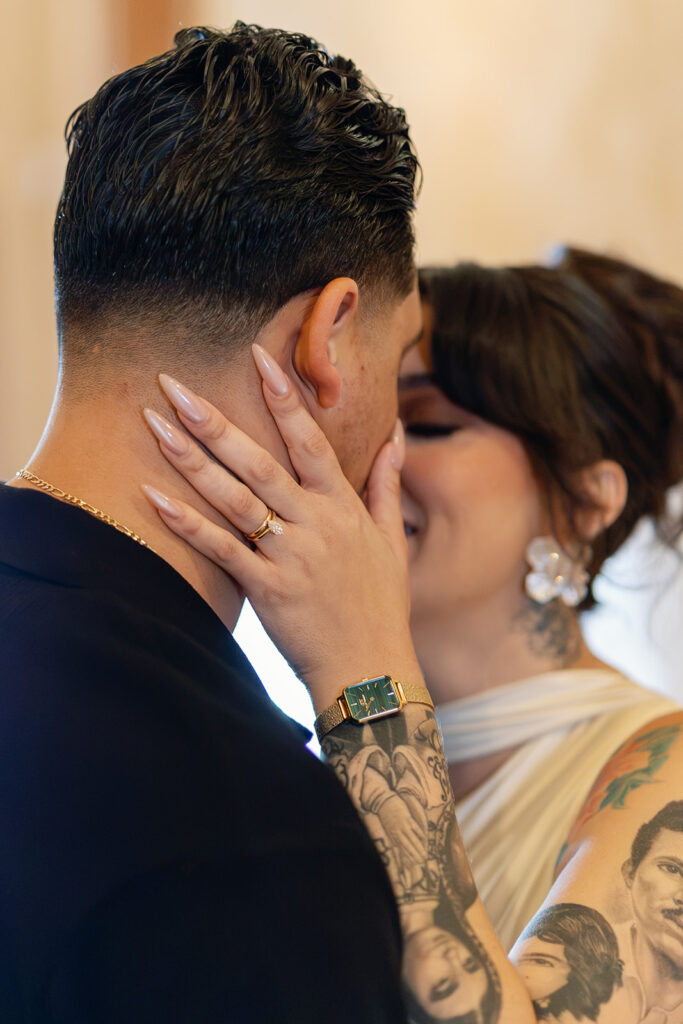 Close up photo of a bride and groom posing.