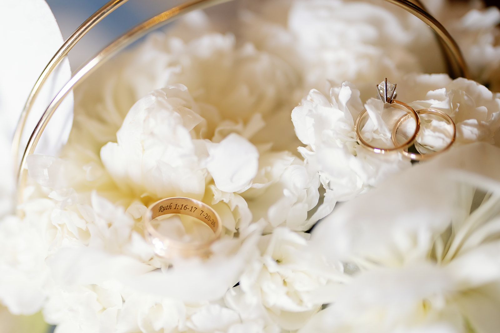 Close up shot of wedding rings styled on a bouquet. 